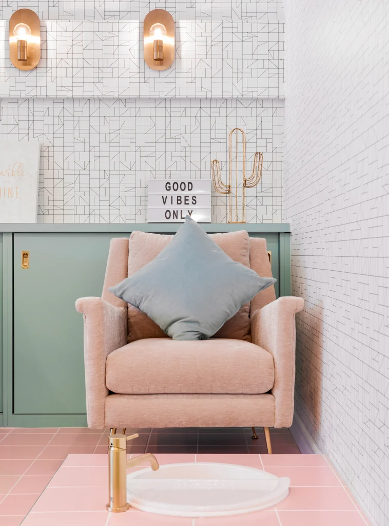 Interior Design - Light pink armchair with a blue cushion and decorative items in a modern interior setting. Dexign Matter Studio