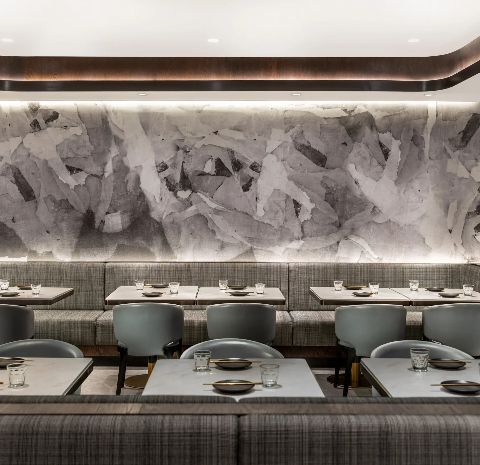 Interior Design - Interior view of a dining area featuring gray textured wall and seating arrangements. Dexign Matter Studio