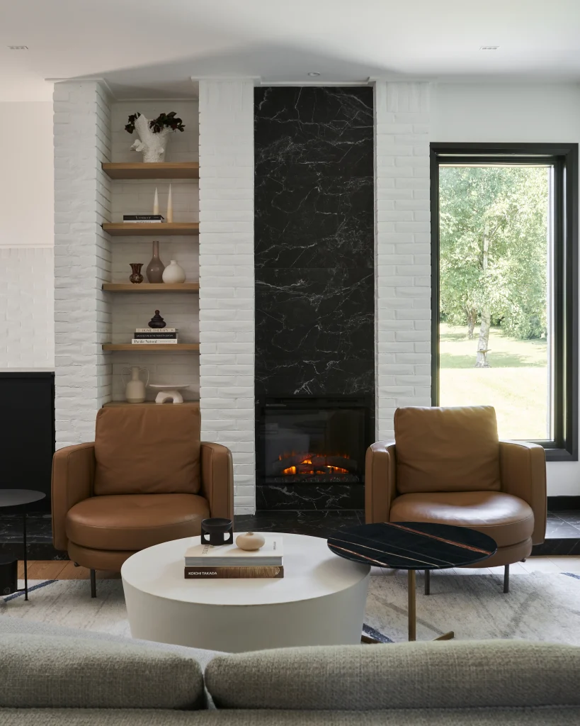 Interior Design - A modern living room featuring two brown leather chairs and a white coffee table. Dexign Matter Studio