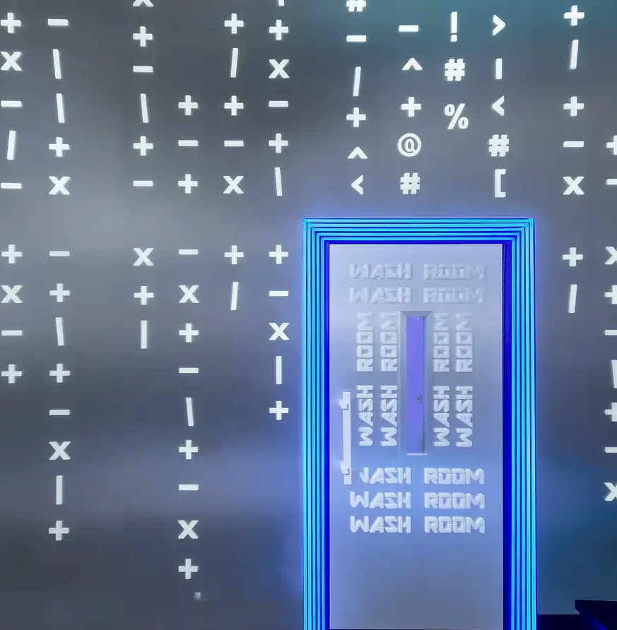 Interior Design - Wall featuring various symbols and a door labeled 'WASH ROOM' with blue lighting. Dexign Matter Studio