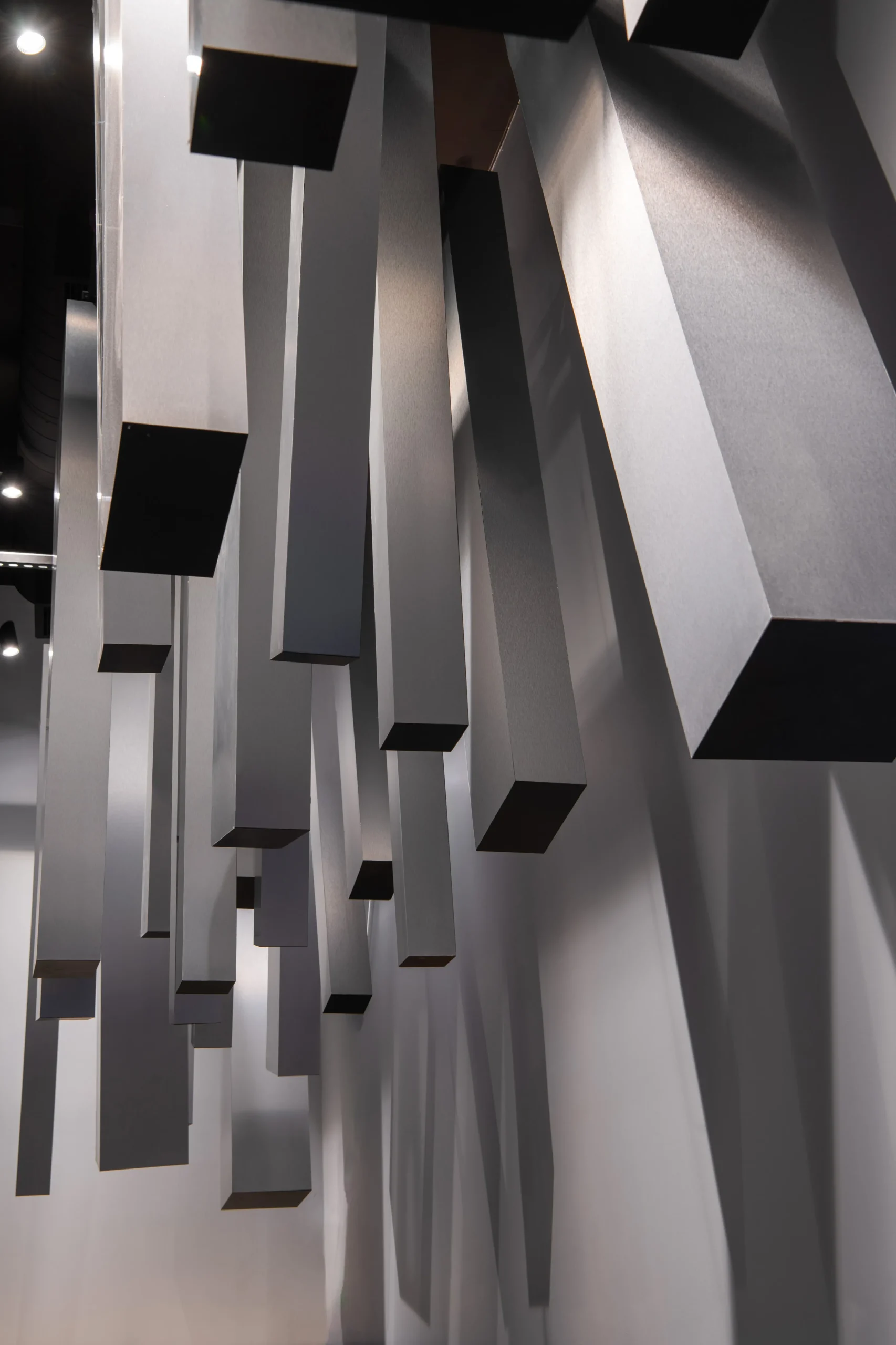 Interior Design - Abstract geometric design featuring hanging rectangular shapes in varying lengths and orientations. Dexign Matter Studio