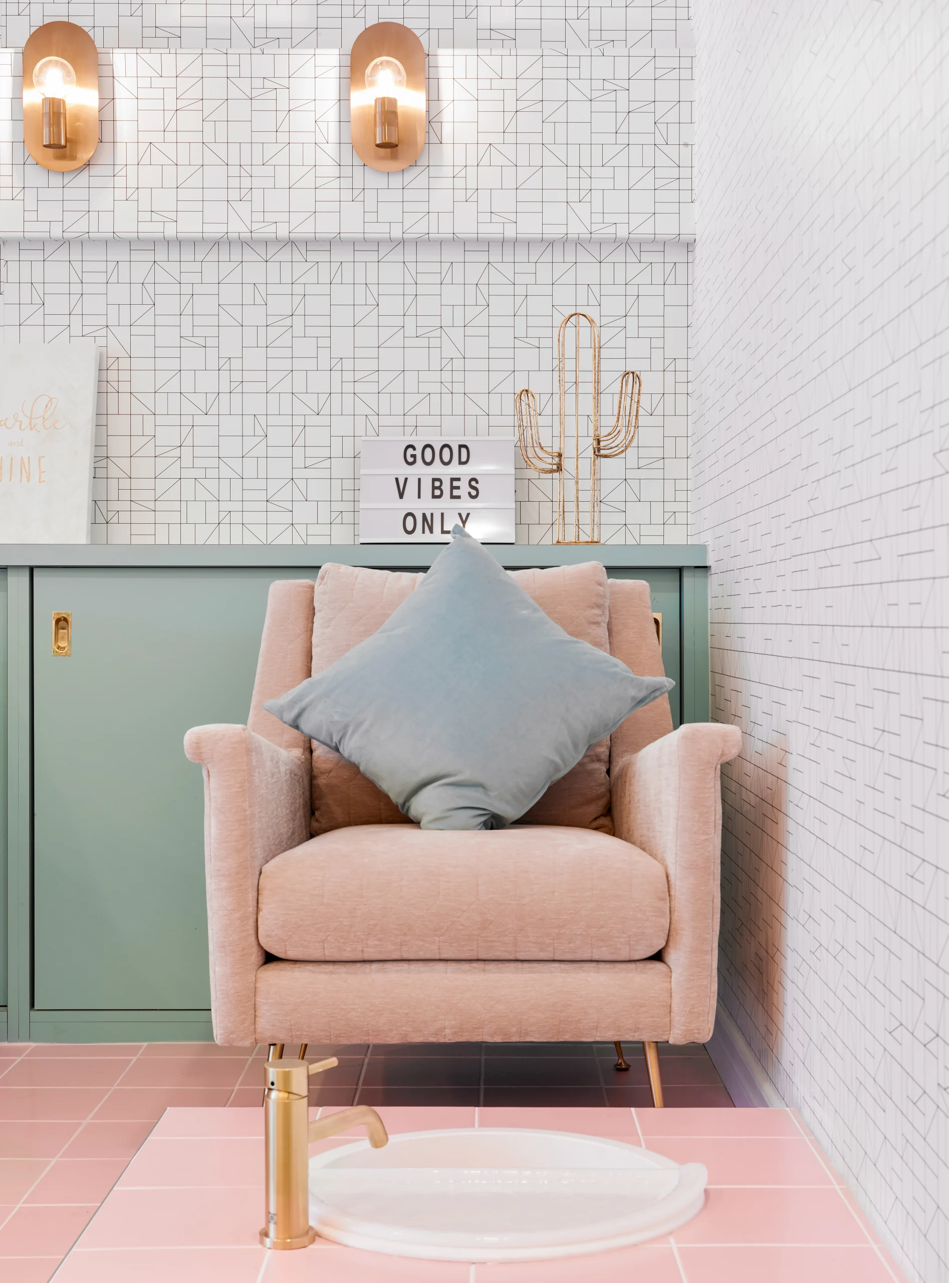 Interior Design - A modern pink armchair with a blue pillow and decorative items in a stylish interior setting. Dexign Matter Studio