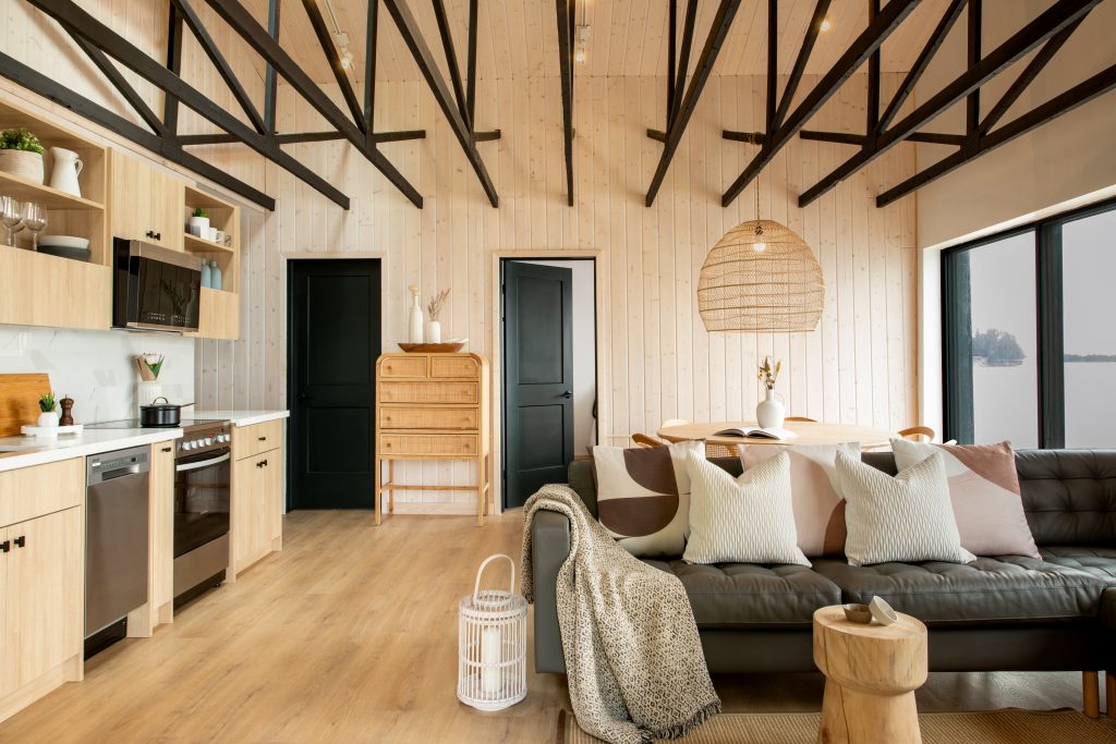 Interior Design - Interior view of a modern cabin featuring a living area with a sofa, dining table, and kitchen appliances. Dexign Matter Studio