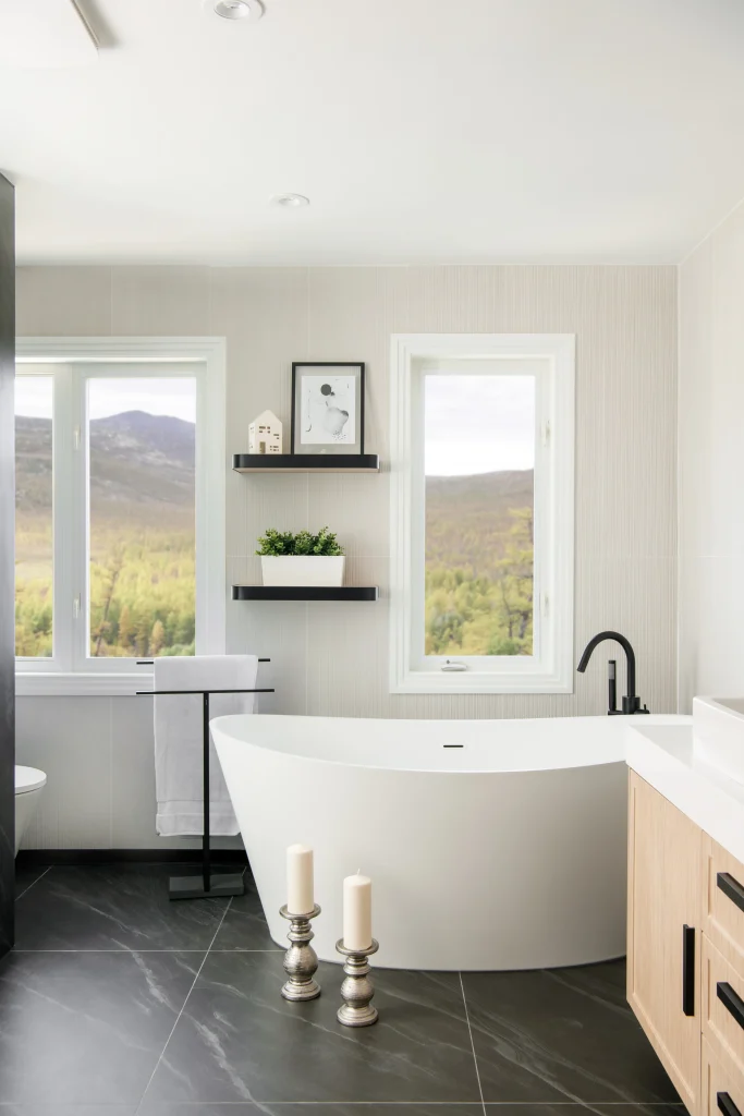 Interior Design - A modern master bathroom featuring a freestanding bathtub, large windows, and minimalist decor. Dexign Matter Studio