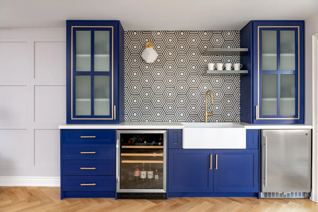 Interior Design - Modern kitchen featuring blue cabinets, a hexagonal patterned backsplash, and a farmhouse sink. Dexign Matter Studio