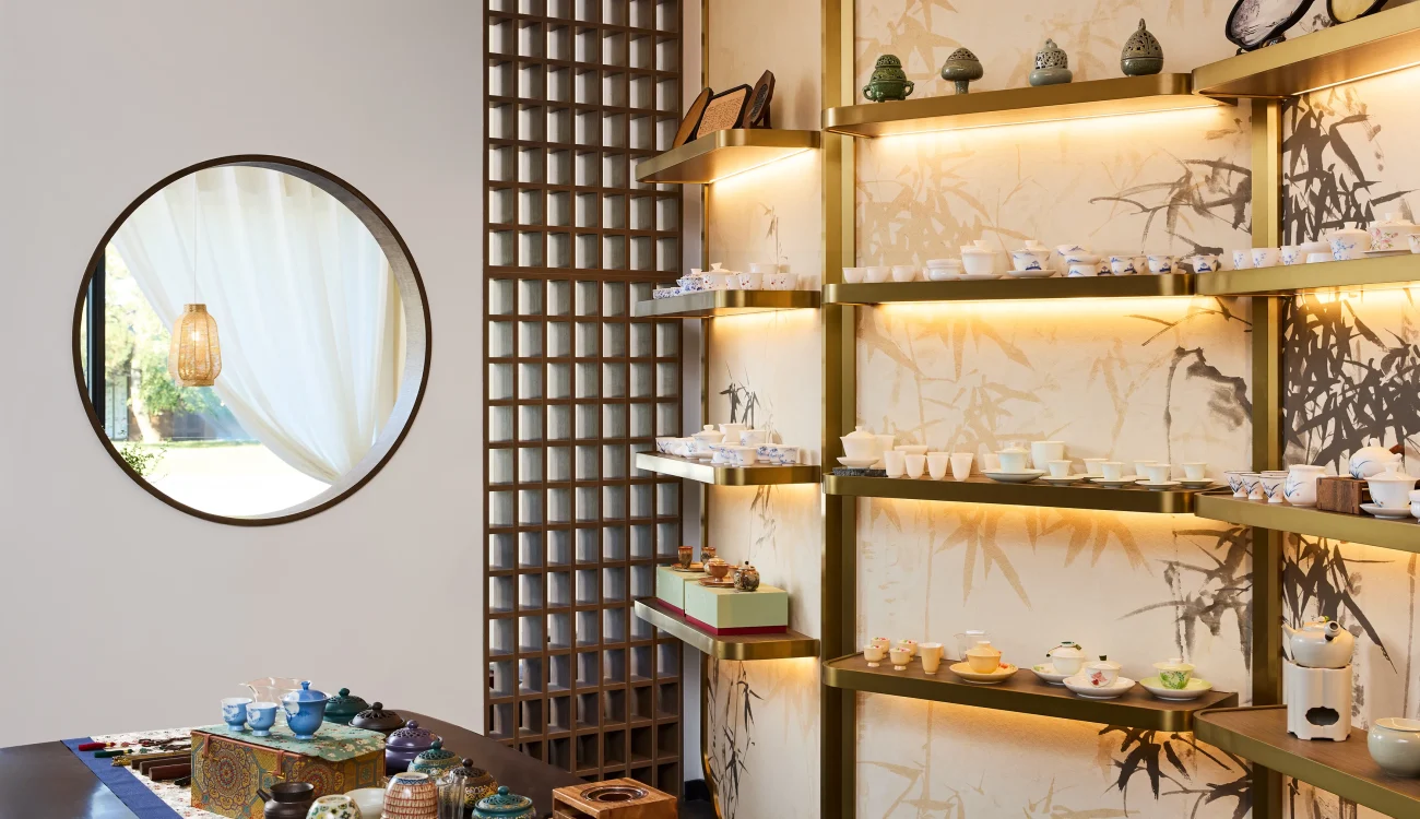 Interior Design - Display of various tea accessories and teapots arranged on shelves in a modern setting. Dexign Matter Studio